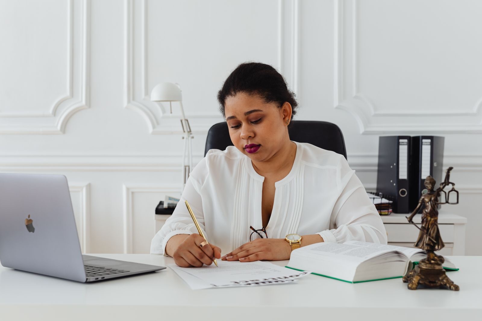 Two professionals reviewing signed corporate documents at a desk