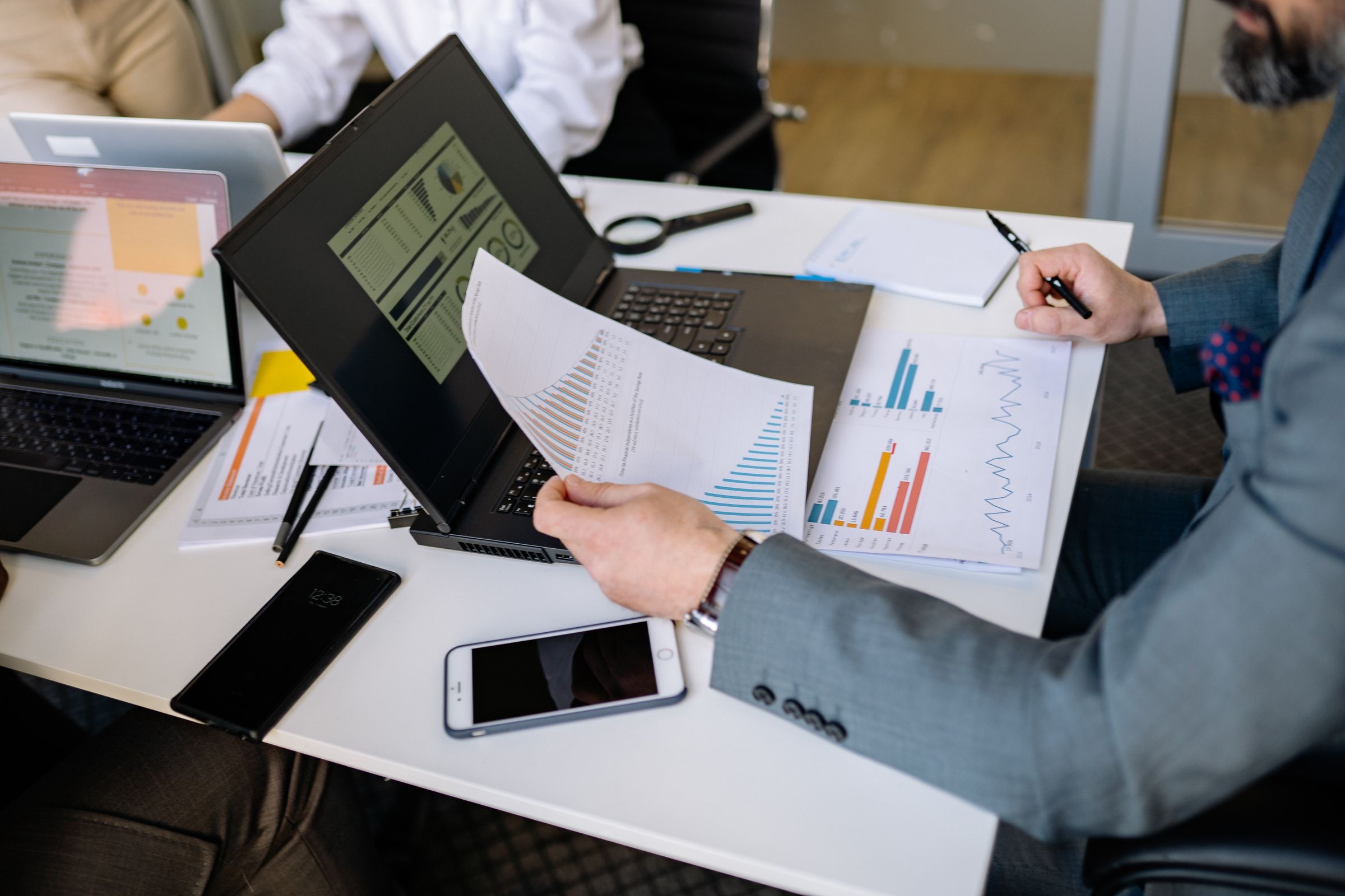 Two people reviewing company incorporation papers at a desk in a daylight office