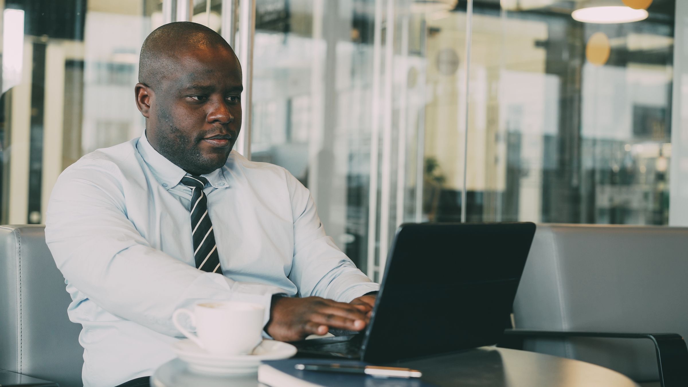 Founder reviewing papers at a laptop in a Brussels office